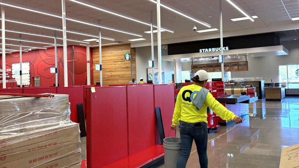 Quality Choice Cleaning crew cleaning a retail floor during a post-construction handover