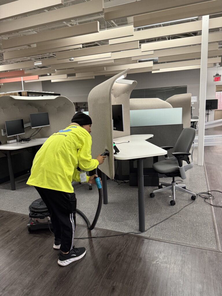 Quality Choice Cleaning technician vacuuming a commercial office floor